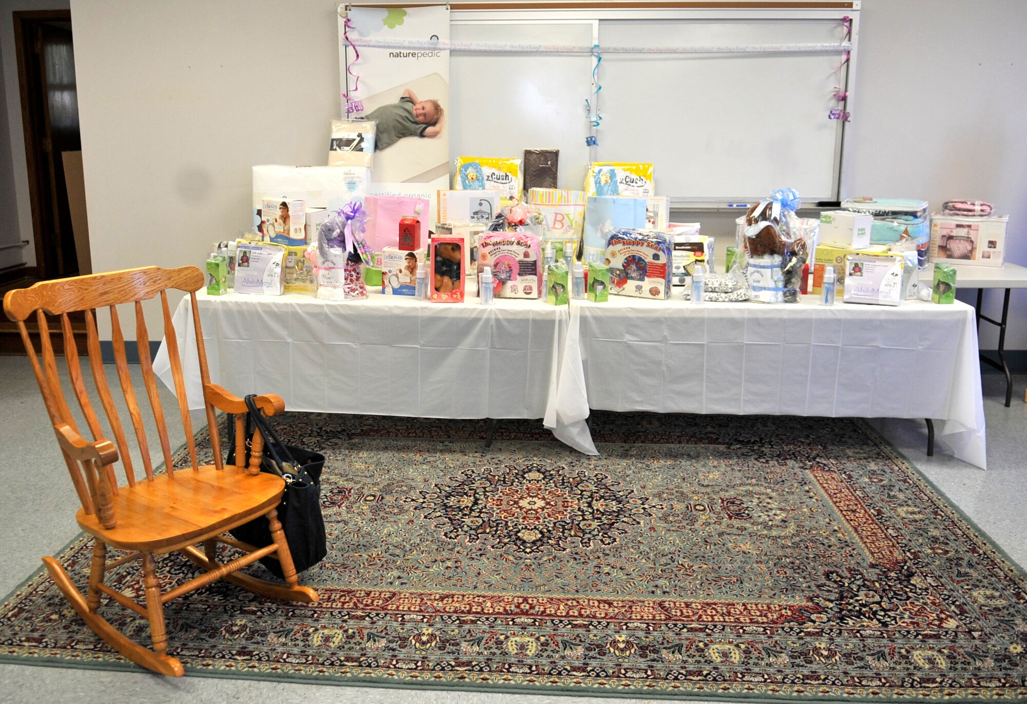 Donations from companies all over the world line the table at Operation Military Shower at the Palmetto Chapel here June 28, 2013. Each of the expecting mothers who attended the event received a donated gift. (U.S. Air Force photo by Airman 1st Class Jonathan Bass/Released)