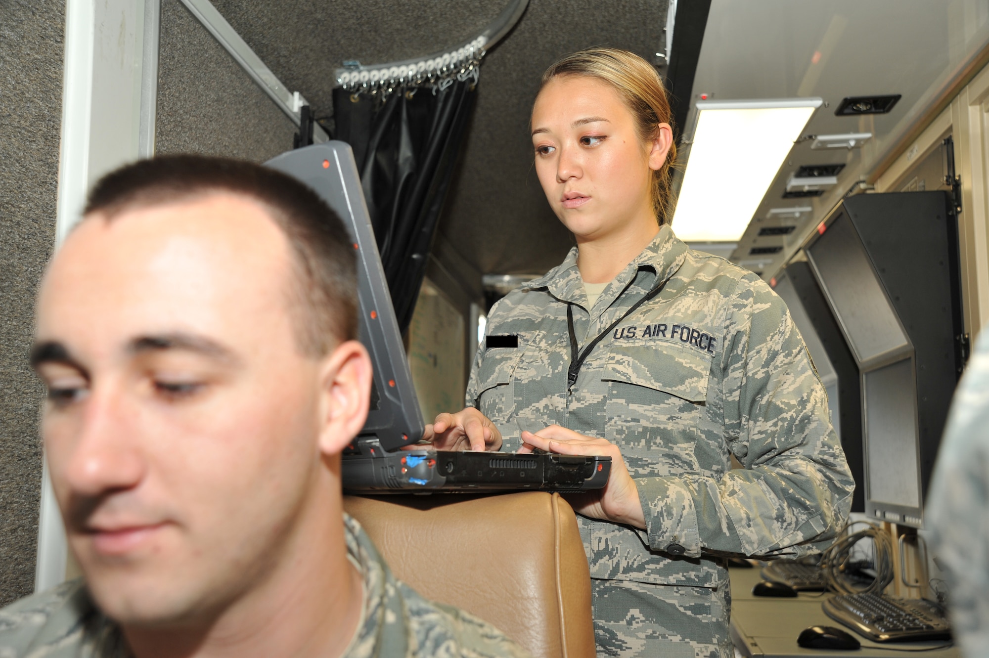 LAS VEGAS, Nev. -- Communication specialists from the 432nd Aircraft Communication Maintenance Squadron complete system checks on a ground control station before a mission June 27, 2013, in support of the 432nd Wing Hunt, a remotely piloted aircraft competition, which took place June 23-28. Nearly a dozen teams from active duty, Reserve and Air National Guard RPA squadrons competed against each other by developing mission plans, evaluating threats and executing combat missions effectively during the competition. [Photo edited for security reasons] (U.S. Air Force photo by Tech. Sgt. S.E./Released)