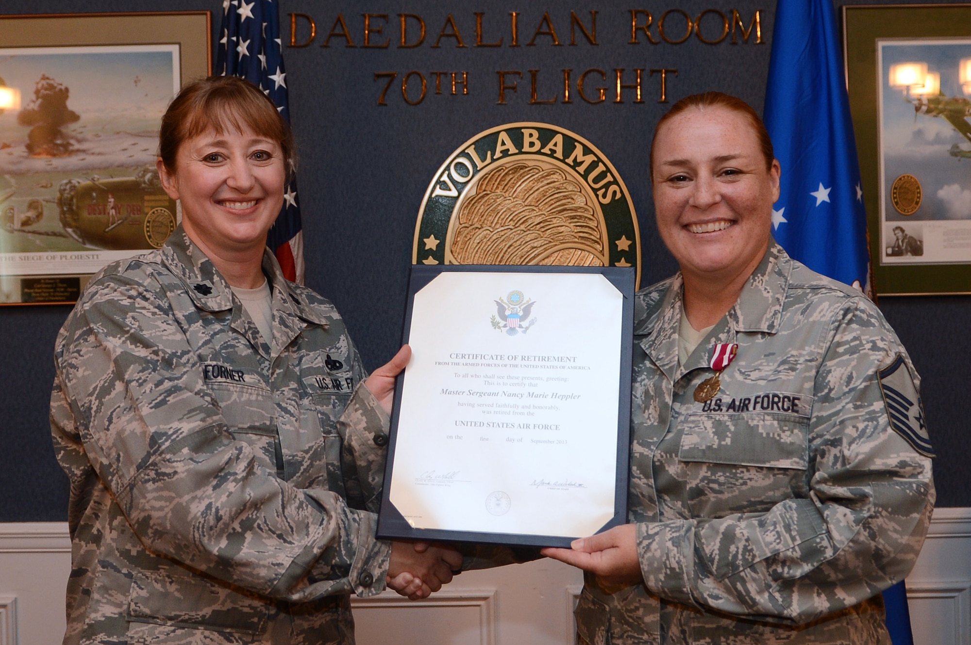 U.S. Air Force Master Sgt. Nancy Heppler, 20th Maintenance Group programs flight chief, receives her certificate of retirement from Lt. Col. Carolyn Forner, 20th MXG deputy commander, at Shaw Air Force Base, S.C., June 28, 2013.  Heppler served in the Air Force for more than 24 years.  (U.S. Air Force photo by Airman 1st Class Nicole Sikorski/Released)