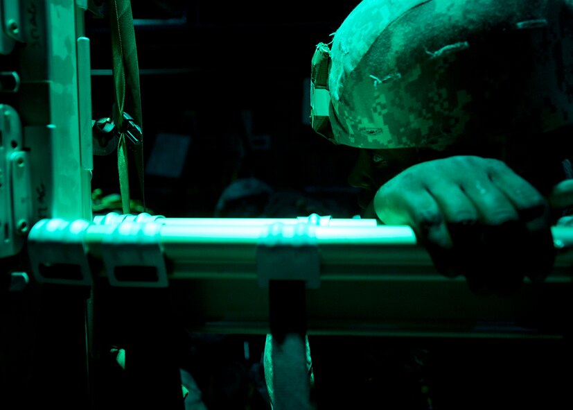 A U.S. Army Soldier from the 82nd Airborne Division, holds on to his seat during Joint Operation Access Exercise above North Carolina, June 24, 2013. JOAX is a combined military training exercise designed to prepare Airmen and Soldiers to respond to worldwide crises and contingencies. While supporting the exercise, Dyess Air Force base, Texas, set the world record for the largest C-130J formation ever flown with 20 aircraft in a single formation. (U.S. Air Force photo by Airman 1st Class Damon Kasberg/Released)