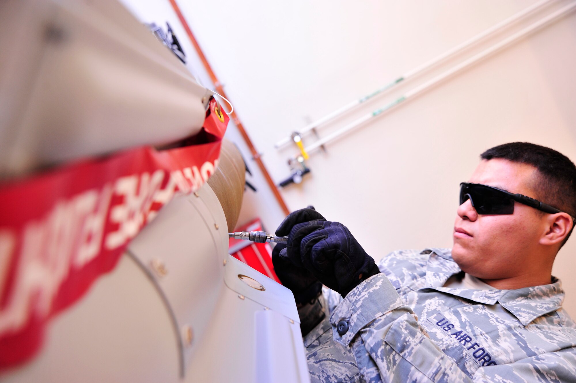 LAS VEGAS, Nev. -- A munitions Airman tightens bolts on a GBU-12 during a bomb build June 19, 2013, in preparation for the 432nd Wing Hunt competition. The bombs were used to further the realism and intensity of the competition, as they were used for live munitions loading on the MQ-9 Reaper. The competition takes place June 23-28 between multiple remotely piloted aircraft squadrons, offering an opportunity for training and demonstration of skill.  During the competition, RPA squadron teams were required to formulate a mission plan, evaluate a threat and develop a strategy to execute the mission effectively. (U.S. Air Force photo illustration by Senior Airman A.K./Released)