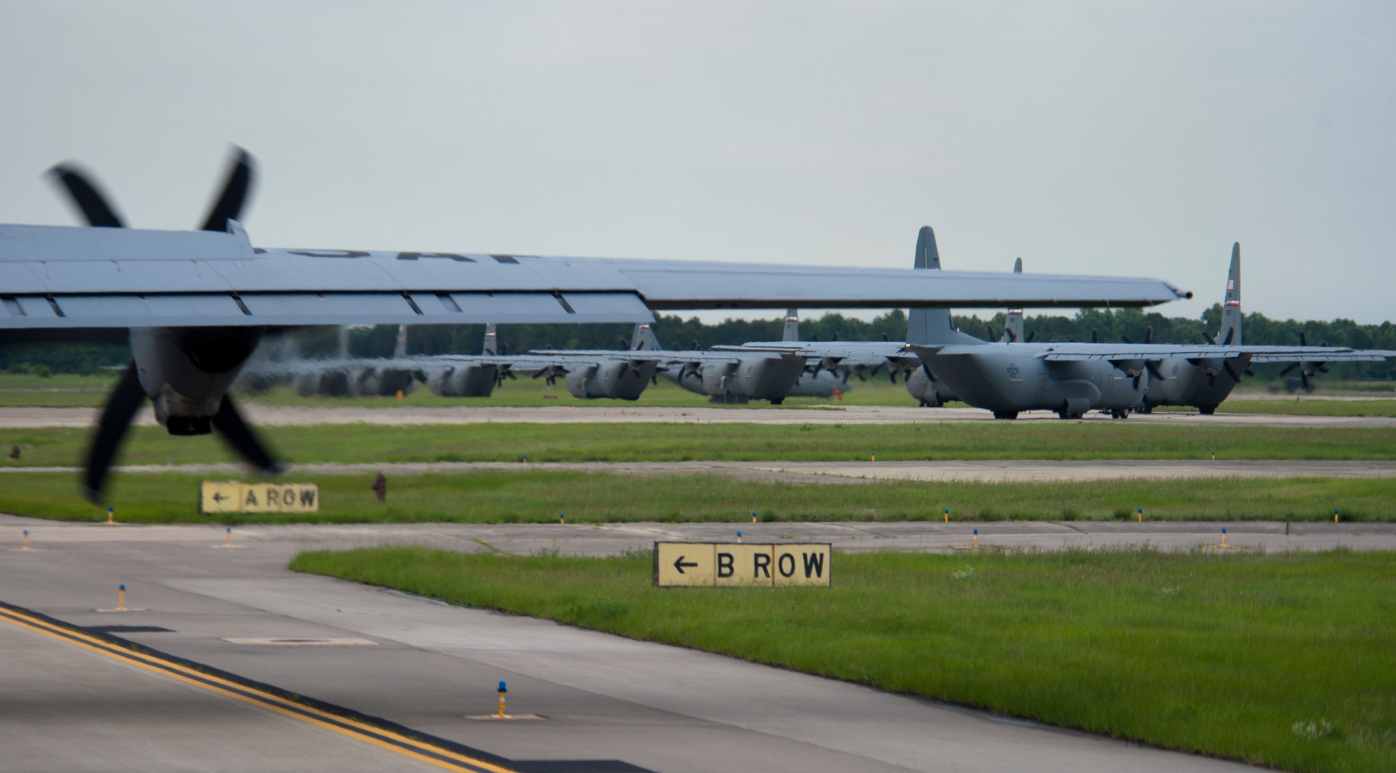U.S. Air Force C-130Js assigned Dyess Air Force base, Texas, taxi down the runway during Joint Operation Access Exercise at Pope Field, N.C., June 24, 2013. The aircrafts are loaded with personal and equipment that were airdropped over multiple drop zones. (U.S. Air Force photo by Airman 1st Class Damon Kasberg/Released)