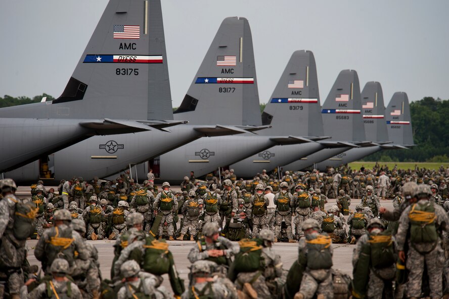 U.S. Army Soldiers from the 82nd Airborne Division ready their gear prior to jumping from U.S. Air Force C-130Js during Joint Operation Access Exercise at Pope Field, N.C., June 24, 2013. A total of 2,426 paratroopers jumped out of C-130Js assigned to Dyess, Air Force Base, Texas, during the 12-day exercise. JOAX is a combined military training exercise designed to prepare Airmen and Soldiers to respond to worldwide crises and contingencies. (U.S. Air Force photo by Airman 1st Class Damon Kasberg/Released)