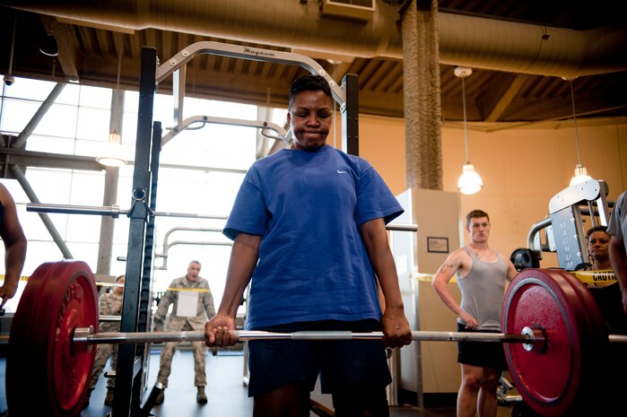 Tech Sgt. Denise Patterson, 57th Aircraft Maintenance Squadron crew chief, dead lifts during the third phase of the weight lifting competition at Nellis Warrior Fitness Center June 28, 2013. She won third place and a $10 gift card. (U.S. Air Force photo by Caitlin Kenney)