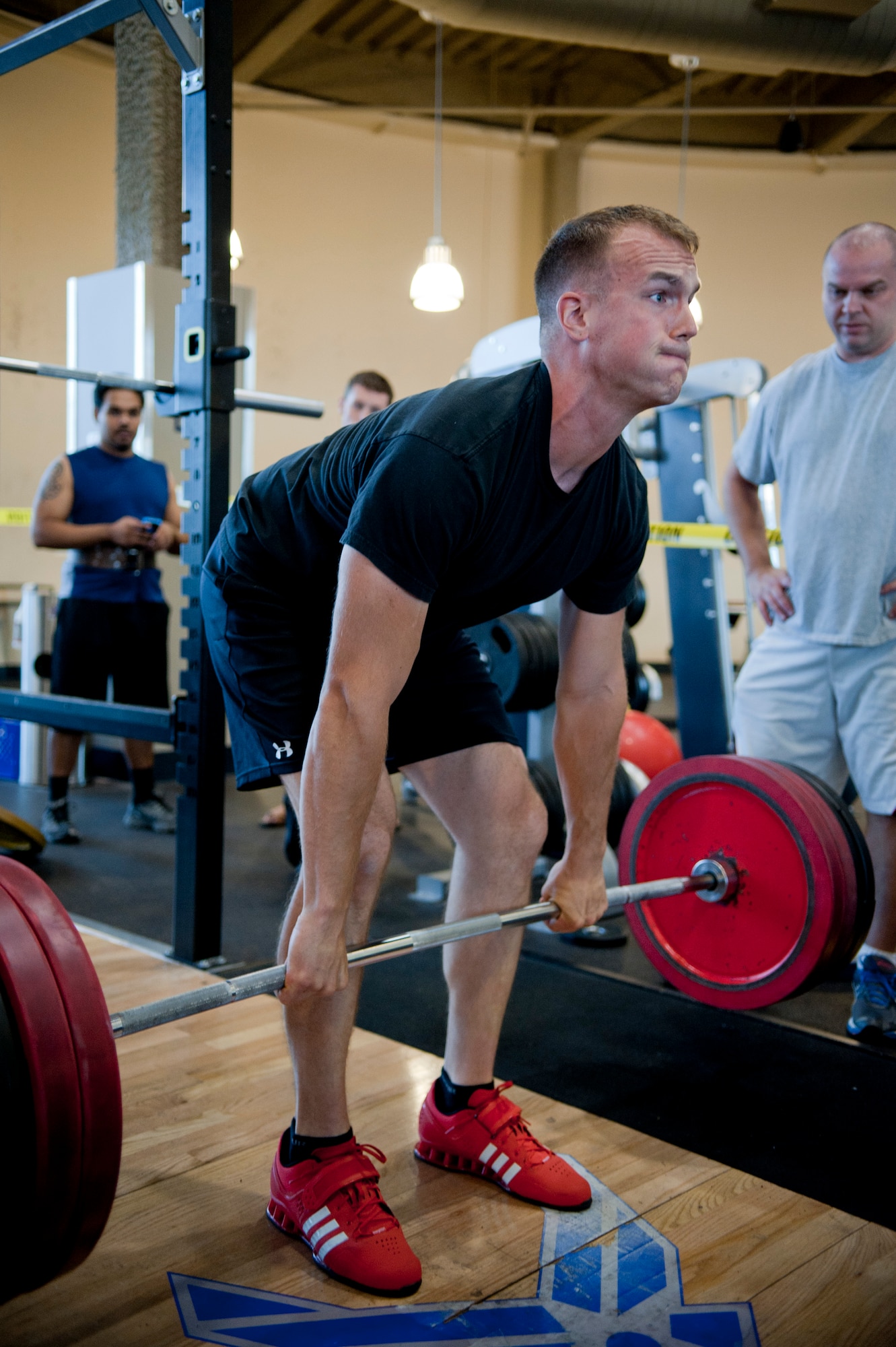 Senior Airman Justin Peschman, 57th Aircraft Maintenance Squadron crew chief, dead lifts 500 pounds during a weight lifting competition at the Nellis Warrior Fitness Center June 28, 2013. Participants did bench presses, squats and dead lifts to tally a winning score. (U.S. Air Force photo by Caitlin Kenney)