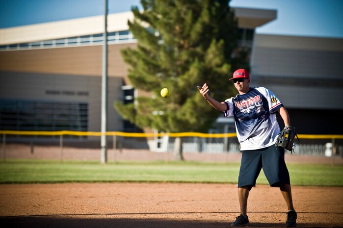Craig Boggs, 57th Aircraft Maintenance Squadron avionics flight chief, pitches the ball during the intramural softball championship game against the 57th Maintenance Squadron June 27, 2013, at Nellis Air Force Base, Nev. Softball games were held across from the Warrior Fitness Center on the fields in Freedom Park. (U.S. Air Force photo by Airman 1st Class Christopher Tam)