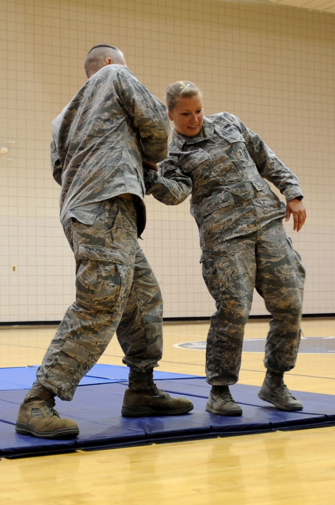 Staff Sgt. Heather Flanagan, 22nd Security Forces Squadron dispatcher, has defensive maneuvers applied to her hand by her “victim,” Tech. Sgt. Daniel Loeb, 22nd Operation Support Squadron first sergeant and Sedgwick County deputy sheriff, during a women’s self-defense class June 27, 2013, at McConnell Air Force Base, Kan. Loeb and Flanagan were presenters during the class, in which participants were given information on how to defend themselves in a personal attack. (U.S. Air Force photo/Senior Airman Laura L. Valentine)