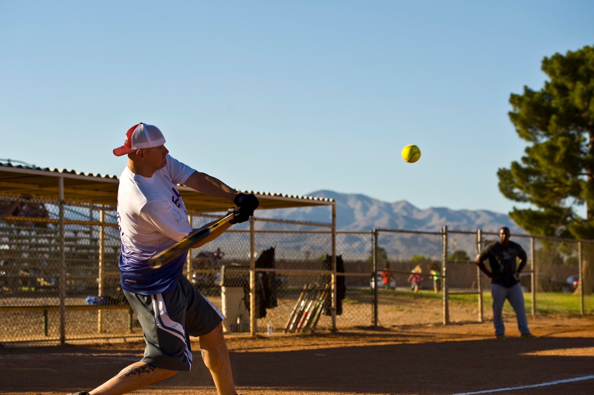 Warren Benge, 57th Aircraft Maintenance Squadron first sergeant, swings the bat during the intramural softball championship game against the 57th Maintenance Squadron June 27, 2013, at Nellis Air Force Base, Nev. The 57th AMXS went undefeated in the 2013 intramural softball season. (U.S. Air Force photo by Airman 1st Class Christopher Tam)