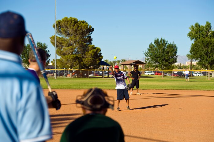 Craig Boggs, 57th Aircraft Maintenance Squadron avionics flight chief, pitches the ball during the intramural softball championship game against the 57th Maintenance Squadron June 27, 2013, at Nellis Air Force Base, Nev. A total of 13 teams participated in the 2013 intramural softball season. (U.S. Air Force photo by Airman 1st Class Christopher Tam)