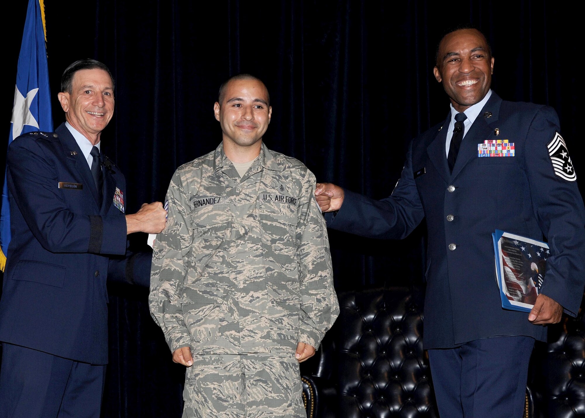 Staff Sgt. David Hernandez is immediately promoted to the rank of Tech. Sgt. by Maj. Gen. Byron Hepburn, 59th Medical Wing commander and director of the San Antonio Military Health System and Command Chief Master Sgt. Maurice James under the Stripes for Exceptional Performers (STEP) program, June 28, 2013, at Wilford Hall Ambulatory Surgical Center. Hernandez is an ophthalmic technician at WHASC. (U.S. Air Force photo/Harold China)