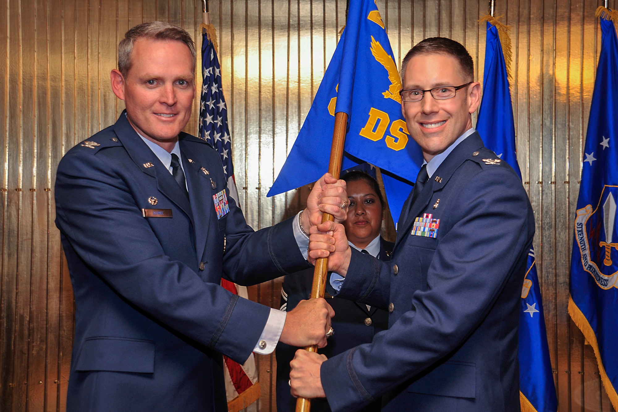 PETERSON AIR FORCE BASE, Colo. – Col. Michael Burke (left), 21st Medical Group commander, passes the 21st Dental Squadron guidon to Col. Donald Sheets, 21st Dental Squadron commander, during a change of command ceremony June 26 at The Club. Sheets replaces outgoing commander Col. James Loe. (U.S. Air Force photo/Dennis Howk)