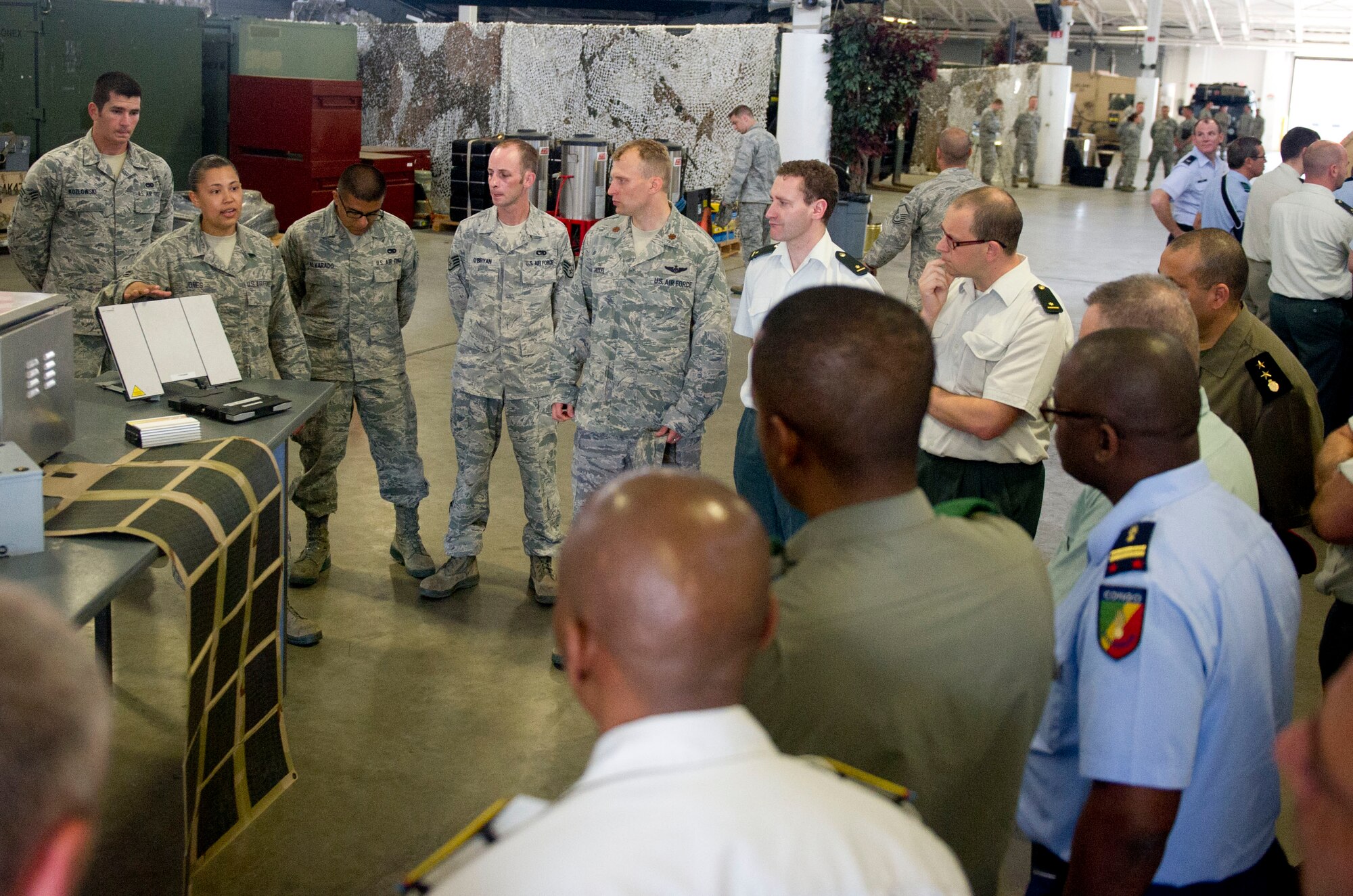 JOINT BASE MCGUIRE-DIX-LAKEHURST, N.J. -- Airman 1st Class Ayisha Jones, 819th Global Support Squadron, briefs students from the Advanced Staff Course at the Royal Military Academy, on in transit visibility during a tour of the 621st Contingency Response Wing, here, June 27, 2013. The tour is part of a yearlong advanced leadership course given in Brussels, Belgium and gives students a chance to gain valuable cross-culturalmilitary experience. (U.S. Air Force photo by Staff Sgt. Gustavo Gonzalez)
