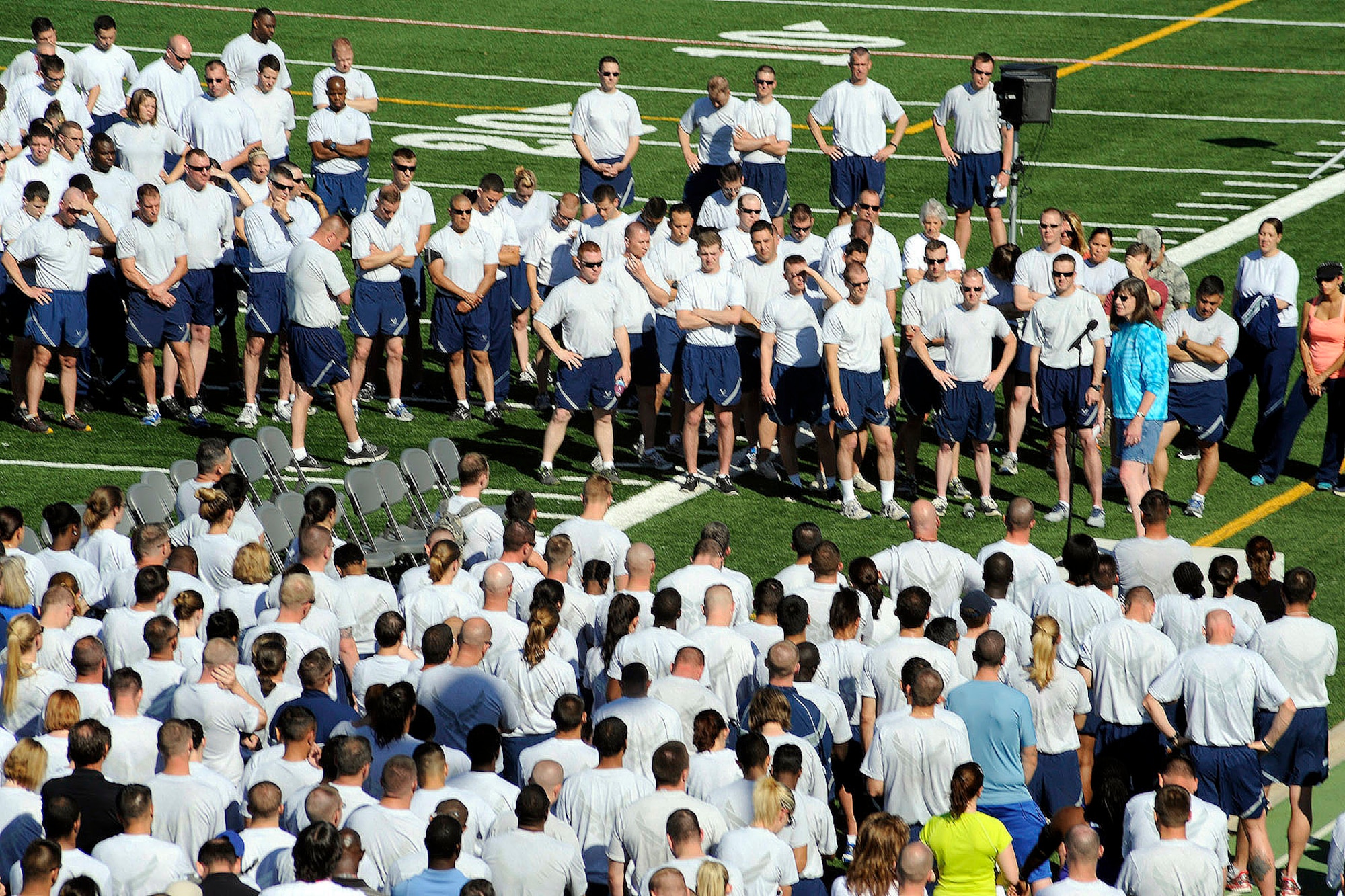 PETERSON AIR FORCE BASE, Colo. – Jeanine Arnold (right), Peterson Sexual Assault Prevention and Response coordinator, begins the 21st Space Wing SAPR stand-down day June 20 on the field behind the fitness center. Arnold said there has been enough cases of sexual assault and it must stop, and to stop sexual assault all Airmen must take action. The stand-down day gave civilian employees and military members an opportunity to discuss the adverse impacts of sexual assault and what can be done to prevent it. (U.S. Air Force photo/Rob Bussard)