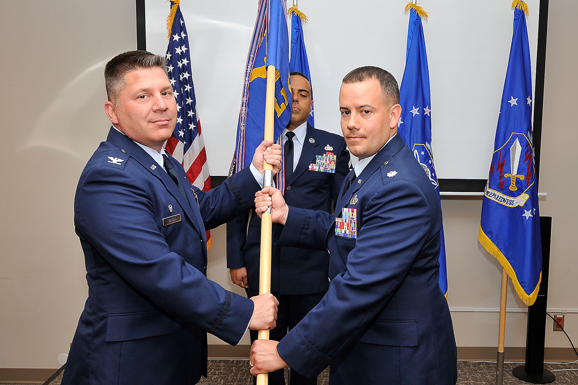 PETERSON AIR FORCE BASE, Colo. -- The 21st Logistics Readiness Squadron held its change of command June 24 in building 123. Col. Charles Arnold, 21st Mission Support Group commander, passes command to Lt. Col. Brady Fischer. Fischer replaces the outgoing commander Lt. Col. James Lovewell. (U.S. Air Force photo/Dennis Howk)