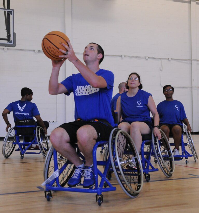 Airman 1st Class Clint Williams take part in wheelchair basketball as part of the Wounded Warriors Adaptive Sports Camp here at Joint Base Andrews on June 26. The wounded warriors could also participate in sitting volleyball, swimming, track and field, archery and air rifle/pistol. (U.S. Air Force Photo by Airman 1st Class Joshua R. M. Dewberry)