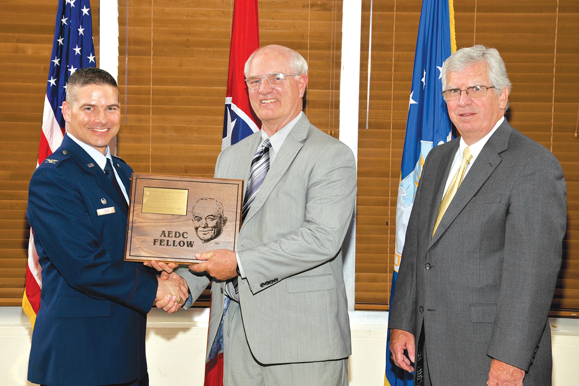 Retired Maj. Gen. Michael Wiedemer (center) receives the AEDC Lifetime Achievement Fellow award from AEDC Commander Col. Raymond Toth (left) and AEDC Chief Scientist Dr. Ed Kraft. (Photo by Rick Goodfriend)
