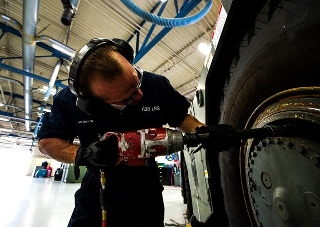 Airman 1st Class Joshua Wachtel, 628th Logistics Readiness Squadron vehicle maintenance technician, removes lug nuts from a vehicle before conducting brake maintenance June 25, 2013, at Joint Base Charleston – Air Base, S.C. Vehicle maintenance technicians maintain JB Charleston's entire vehicle fleet, keeping cars, trucks and buses operating smoothly. (U.S. Air Force photo/ Senior Airman George Goslin)