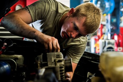 Senior Airman Matthew Fincher, 628th Logistics Readiness Squadron vehicle maintenance technician, installs a part in a truck June 25, 2013, at Joint Base Charleston – Air Base, S.C. Vehicle maintenance technicians maintain JB Charleston's entire vehicle fleet, keeping cars, trucks and buses operating smoothly. (U.S. Air Force photo/ Senior Airman George Goslin)