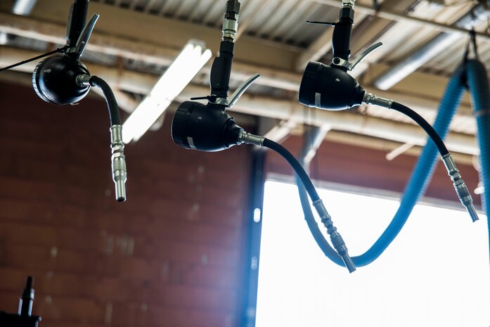 Oil, grease, and transmission fluid dispensers hang in the 628th Logistics Readiness Squadron vehicle maintenance shop bay June 25, 2013, at Joint Base Charleston – Air Base, S.C. The hoses make it easier for the maintainers to have quick access to the fluids they need.. (U.S. Air Force photo/ Senior Airman George Goslin)