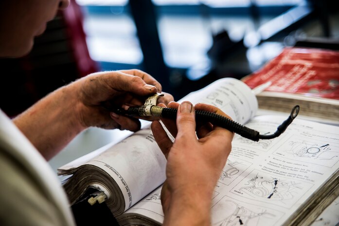 Senior Airman Matthew Fincher, 628th Logistics Readiness Squadron vehicle maintenance technician, compares a part for a truck to a reference manual while conducting maintenance June 25, 2013, at Joint Base Charleston – Air Base, S.C. Vehicle maintenance technicians maintain JB Charleston's entire vehicle fleet, keeping cars, trucks and buses operating smoothly. (U.S. Air Force photo/ Senior Airman George Goslin)