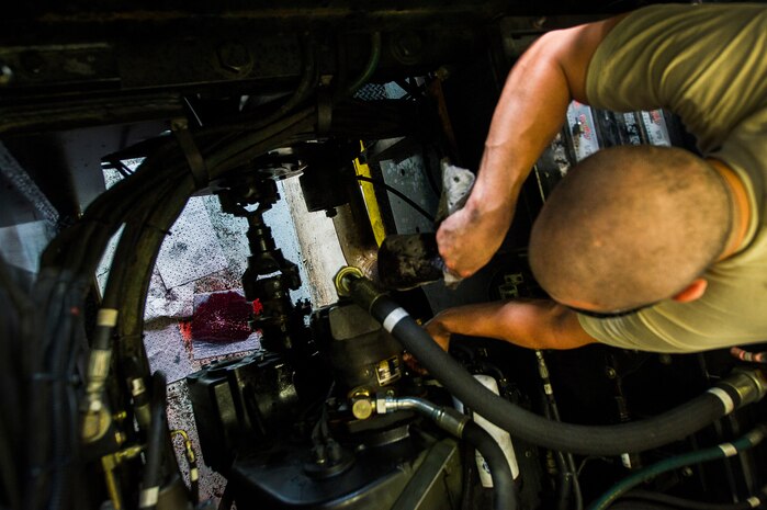 Senior Airman Matthew Trevino fixes a hydraulic fluid leak on a vehicle June 25, 2013, at Joint Base Charleston – Air Base, S.C. Vehicle maintenance technicians maintain JB Charleston's entire vehicle fleet, keeping cars, trucks and buses operating smoothly. (U.S. Air Force photo/ Senior Airman George Goslin)