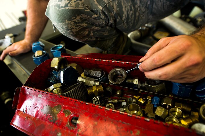 Airman 1st Class Joshua Wachtel, 628th Logistics Readiness Squadron vehicle maintenance technician, looks for the proper tool while conducting maintenance on a vehicle June 25, 2013, at Joint Base Charleston – Air Base, S.C. Vehicle maintenance technicians maintain JB Charleston's entire vehicle fleet, keeping cars, trucks and buses operating smoothly. (U.S. Air Force photo/ Senior Airman George Goslin)