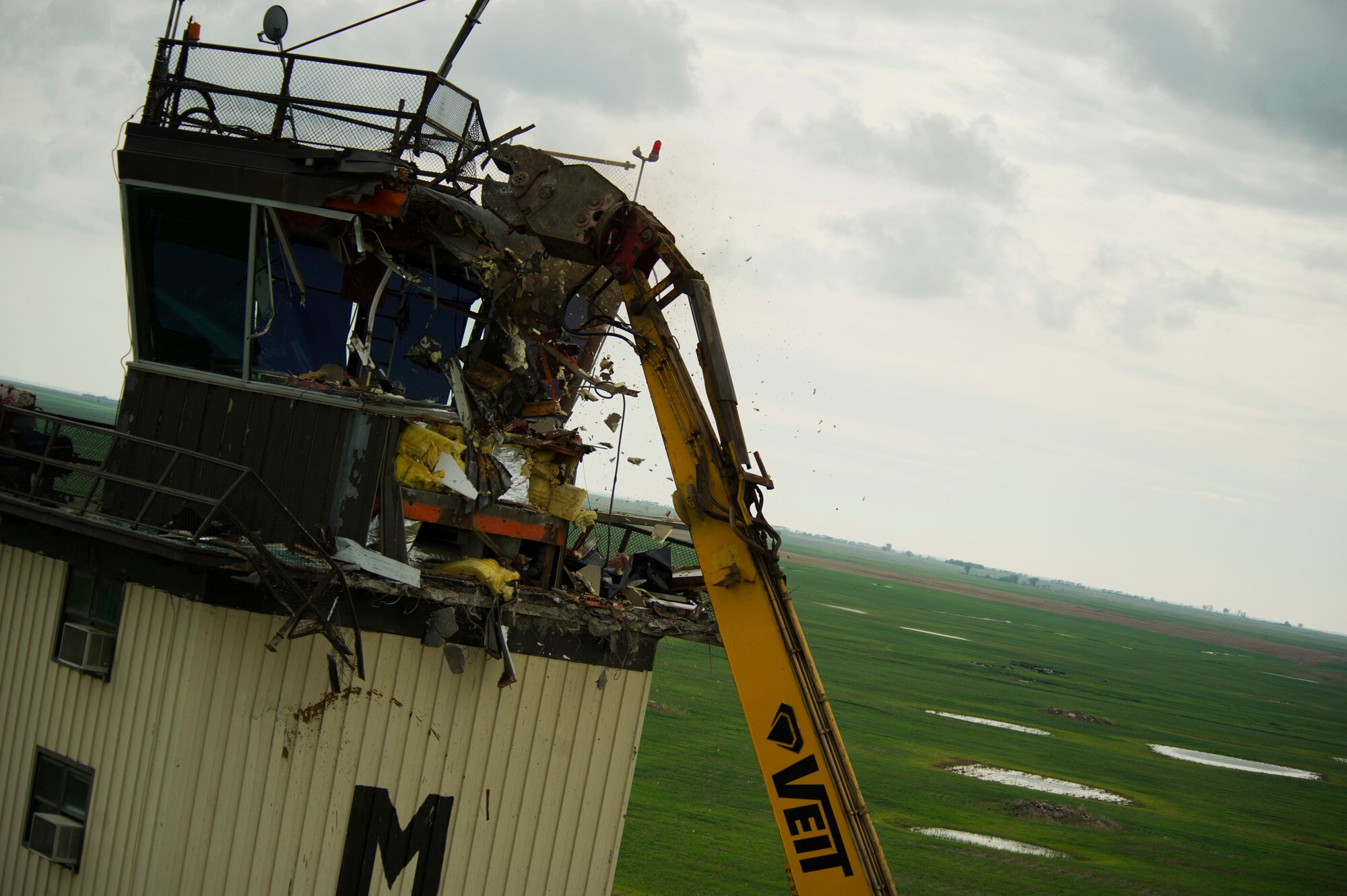 The old air control tower goes through the demolition process at Minot Air Force Base, N.D., June 21, 2013. The new tower is built adjacent to the old tower on the south side of the runway. The old tower went into service Jan. 1, 1966. (U.S. Air Force photos/Senior Airman Brittany Y. Auld)

