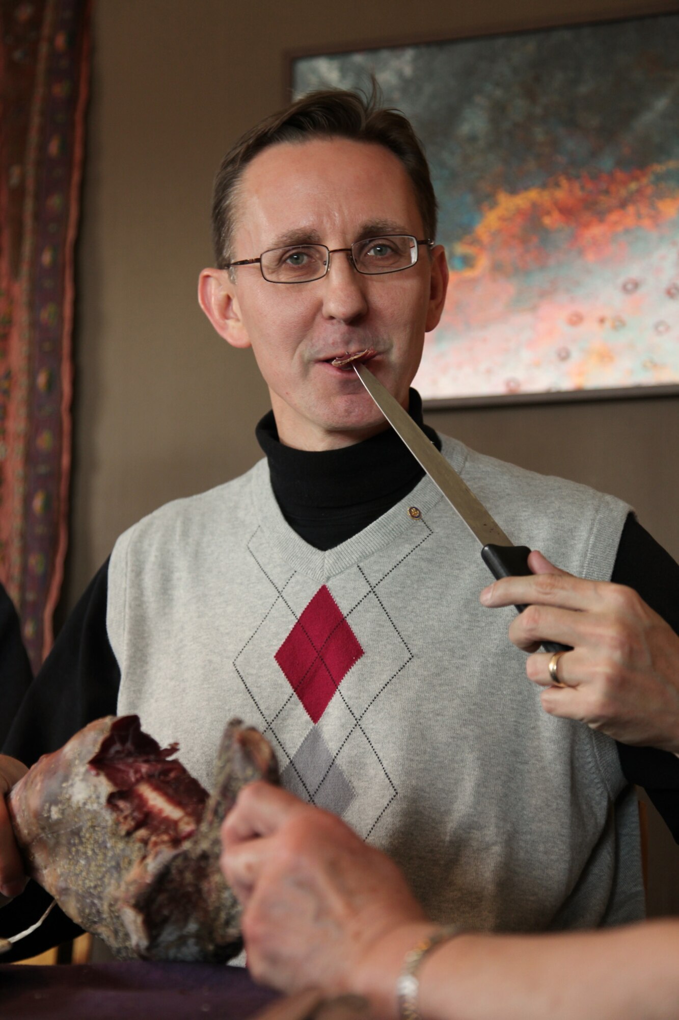 Greg Sandlin, an ATA senior engineer, partakes in a traditional 12th century Viking meal of salt-cured lamb, no fork, while visiting Norway as a Rotary Group Study Exchange team leader. (Photo Provided)