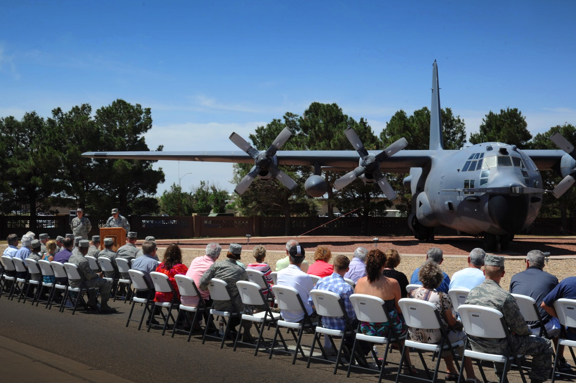 Spectators gather near the Combat Talon I, tail number 64-0523, during a ceremony officially welcoming the retired aircraft to its new home by the front gate of Cannon Air Force Base, N.M., June 28, 2013.  The Talon flew point in the largest covert operation of the Vietnam War, the Son Tay Raid, to rescue Prisoners of War.  (U.S. Air Force photo/Senior Airman Jette Carr)