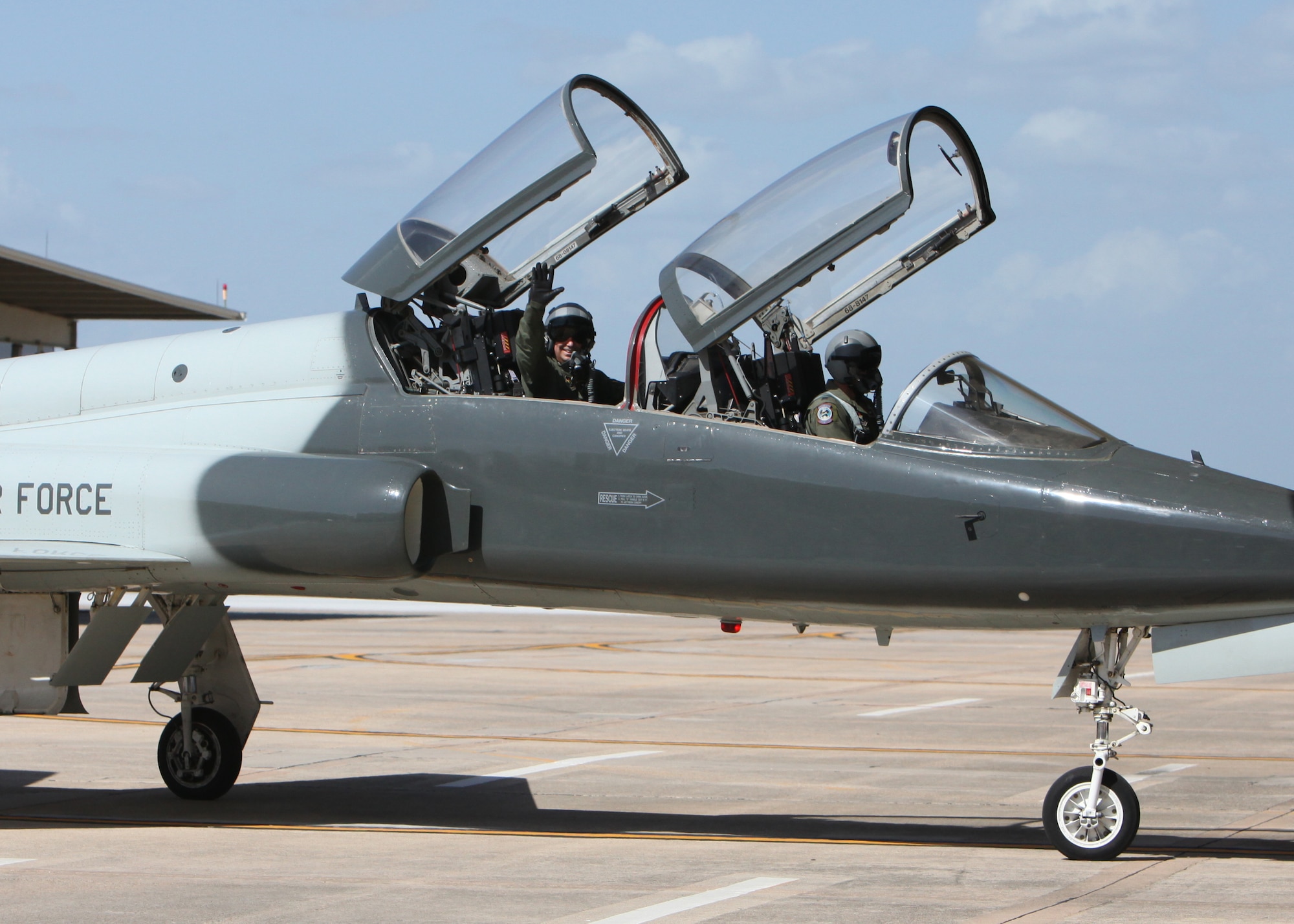 Col. David Drichta, 12th Operations Group deputy commander, waves from the backseat of his T-38 after his first flight back after his battle with cancer at Joint Base San Antonio-Randolph, Texas June 19, 2013.  Drichta was diagnosed with Stage IV cancer in February 2012 and, after more than a year in recovery, was medically cleared to return to flight status.  The flight marked his return to flight status as well as his 3,000th flight hour in Air Force aircraft. (Courtesy photo by Stacy Nyikos)