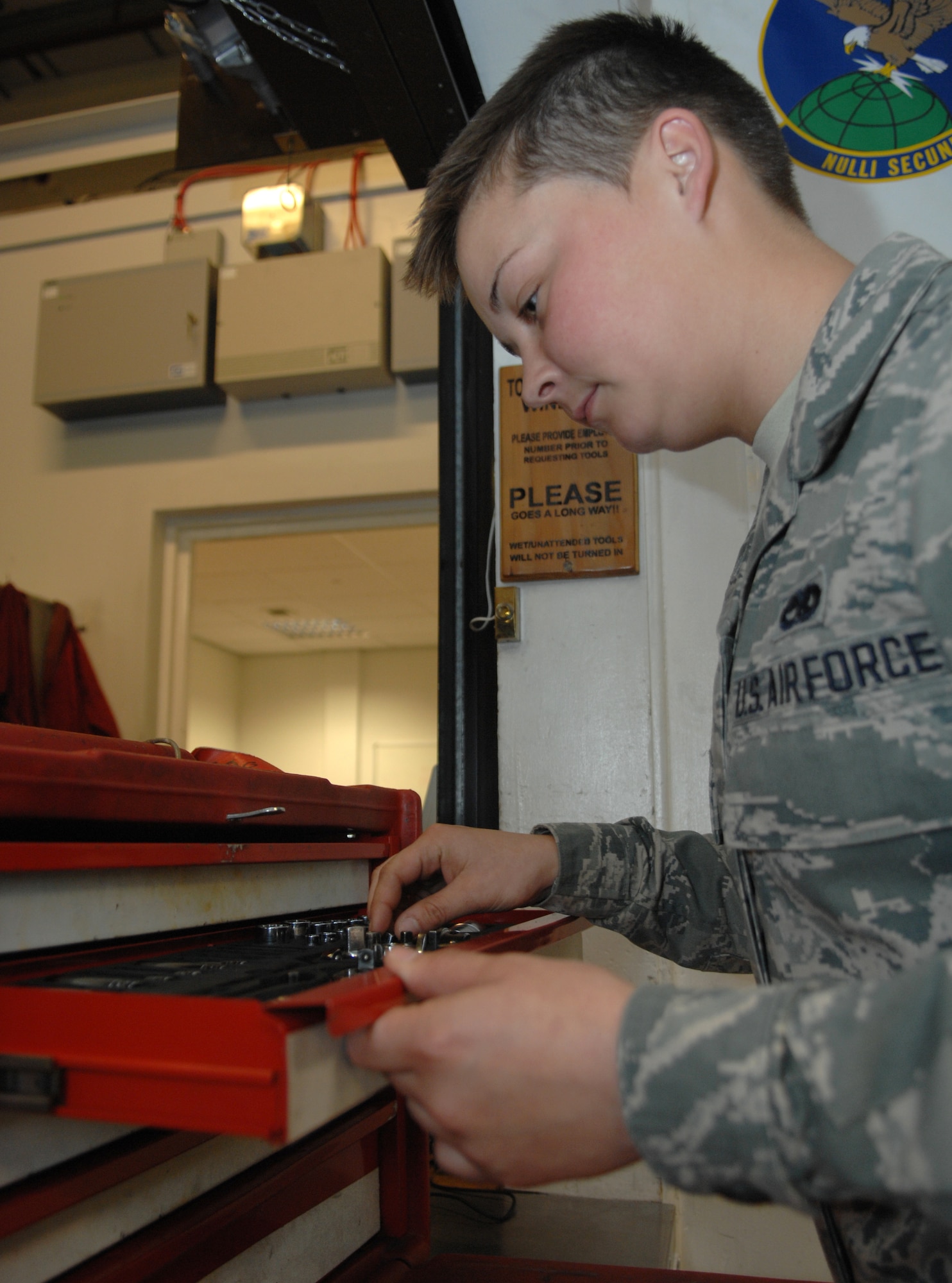 Airman 1st Class Alyce Stahler, 100th Aircraft Maintenance Squadron aerospace maintenance apprentice, inspects her tools before going to the flight line June 26, 2013, on RAF Mildenhall, England. Stahler was selected for the Square D Spotlight for exhibiting the Air Force core value “Service Before Self.” (U.S. Air Force photo by Airman 1st Class Dillon Johnston/Released)