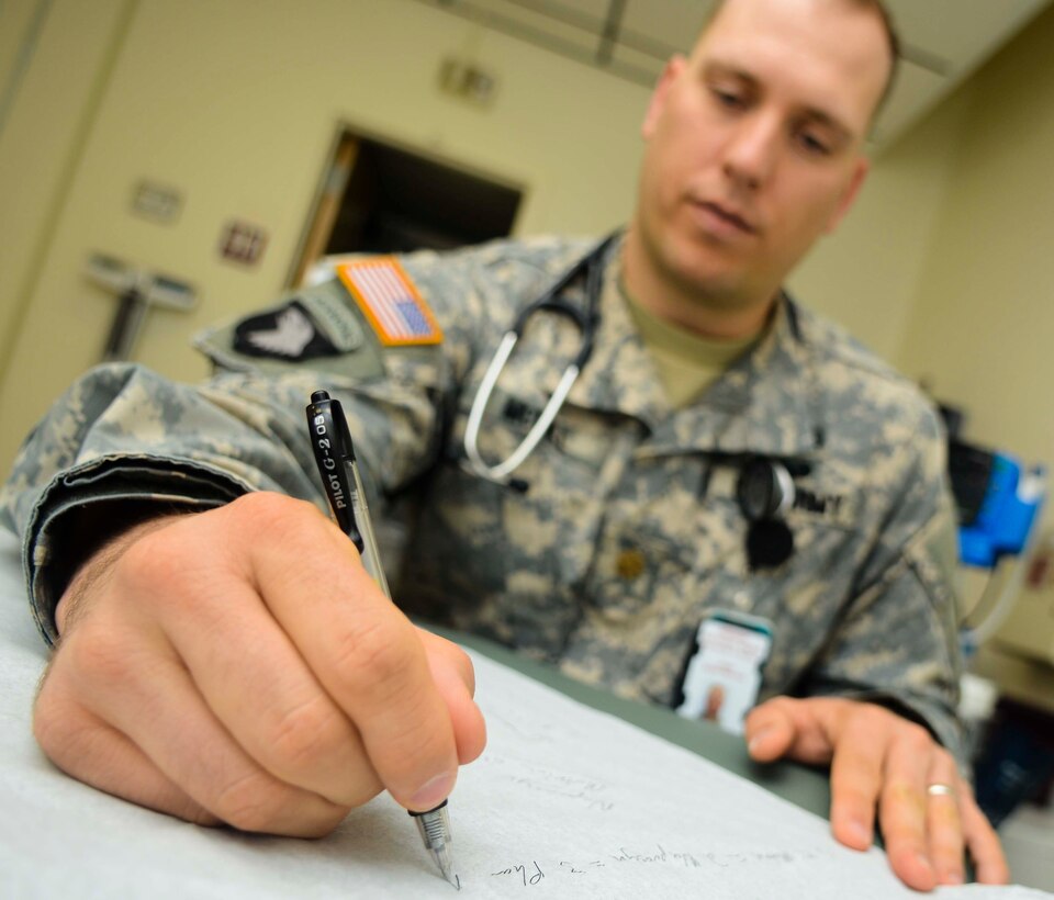 U.S. Army Maj. Ryan McGill, Troop Medical Center 2 physician, writes down ideas for a treatment plan with a patient, June 19, 2013, at Fort Eustis, Va. TMC2 uses the “Patient-Centered Medical Home” approach to care of patients, and has more than doubled the percentage of patients who see the same physician consistently. (U.S. Air Force photo by Airman 1st Class Austin Harvill/Released)

