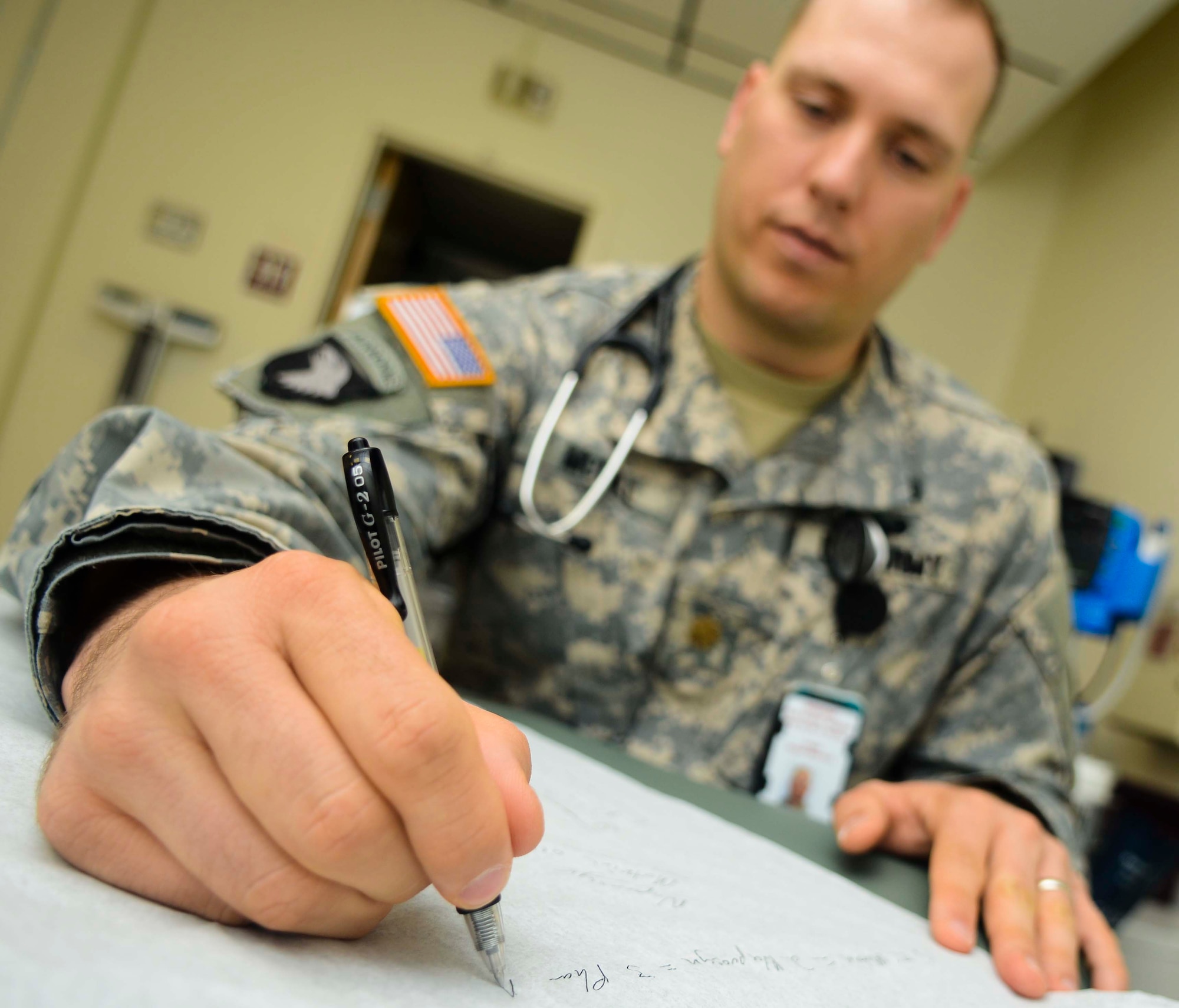 U.S. Army Maj. Ryan McGill, Troop Medical Center 2 physician, writes down ideas for a treatment plan with a patient, June 19, 2013, at Fort Eustis, Va. TMC2 uses the “Patient-Centered Medical Home” approach to care of patients, and has more than doubled the percentage of patients who see the same physician consistently. (U.S. Air Force photo by Airman 1st Class Austin Harvill/Released)

