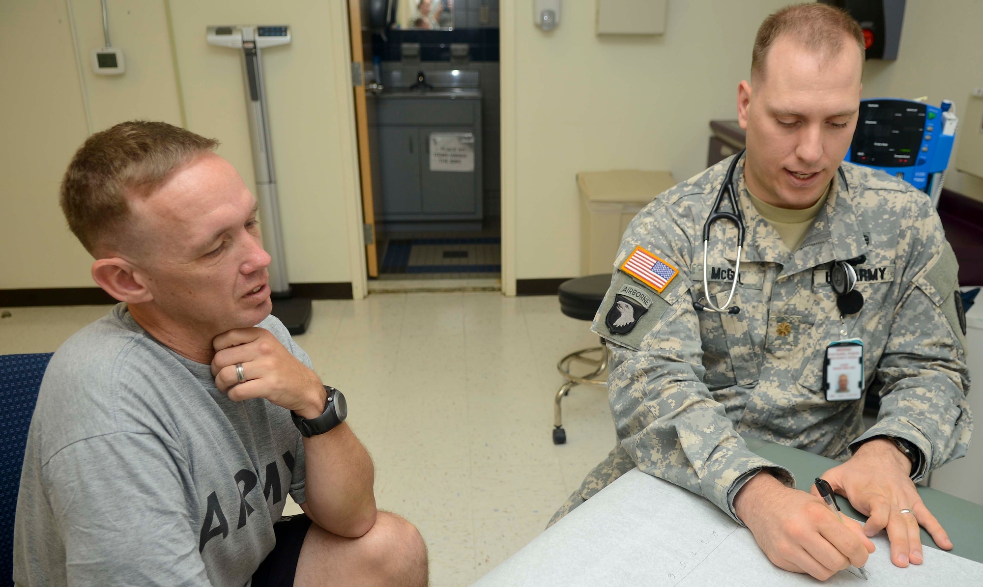 U.S. Army Maj. Ryan McGill, Troop Medical Center 2 physician, writes down a chart on prescription drugs for U.S. Army Sgt. 1st Class Danny Weatherly, U.S. Army Training and Doctrine Command training programs writer, June 19, 2013, at Fort Eustis, Va. TMC2 is the first Patient-Centered Medical Home at Fort Eustis. (U.S. Air Force photo by Airman 1st Class Austin Harvill/Released)

