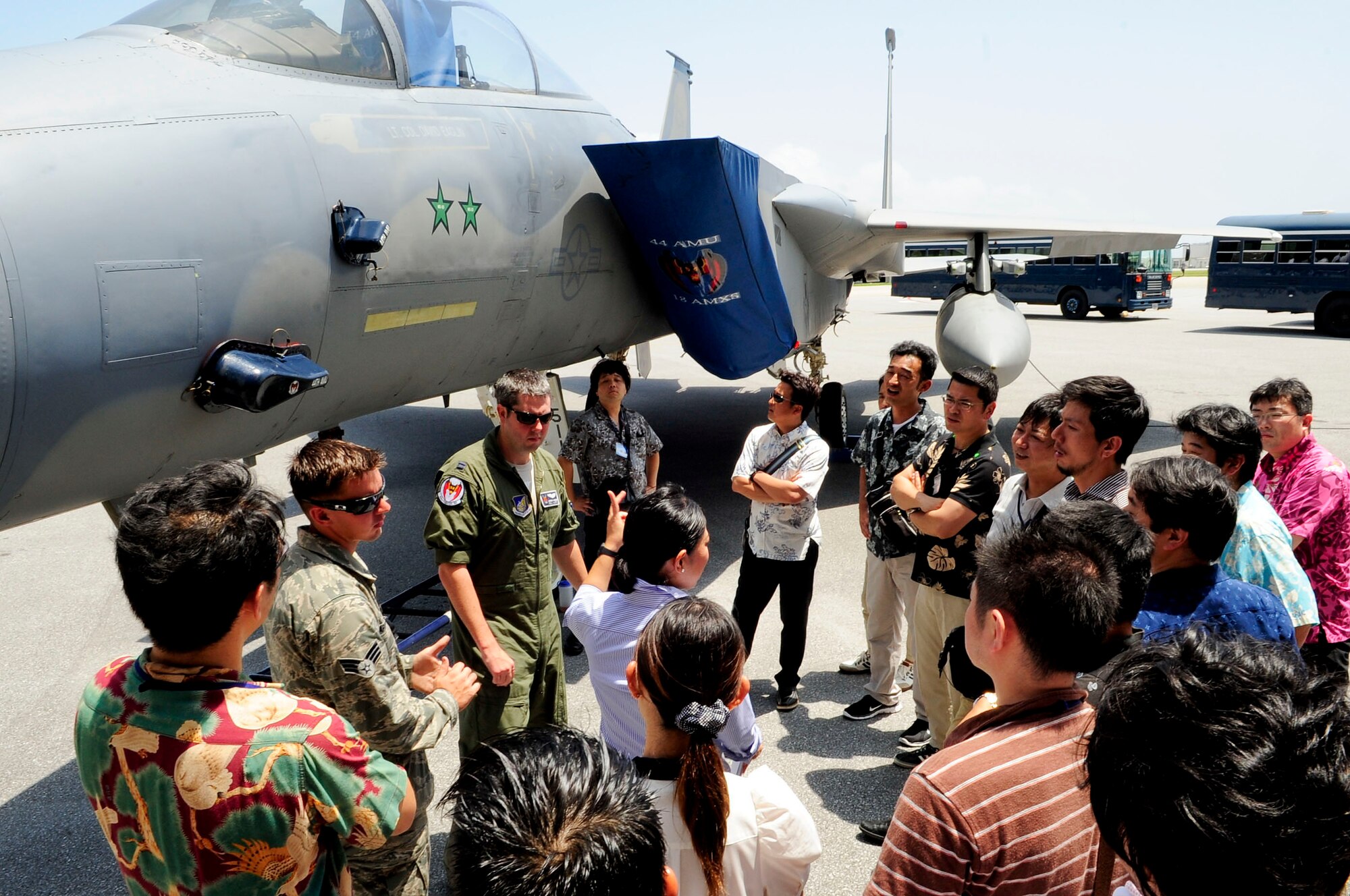 Sayaka Kawatake (middle), 18th Wing community relations specialist, translates information from U.S. Air Force Capt. Joshua Hudson (left), 44th Fighter Squadron F-15 Eagle aircraft commander, to Junior Chamber International Japan members during their study tour visit to Kadena Air Base, Japan, June 28, 2013. This visit to Okinawa allowed the members to learn about the U.S. military's mission and role in the region, as well as the relationship between the U.S. forces and the Japan Self-Defense Force.  (U.S. Air Force photo by Staff Sgt. Darnell T. Cannady/Released)