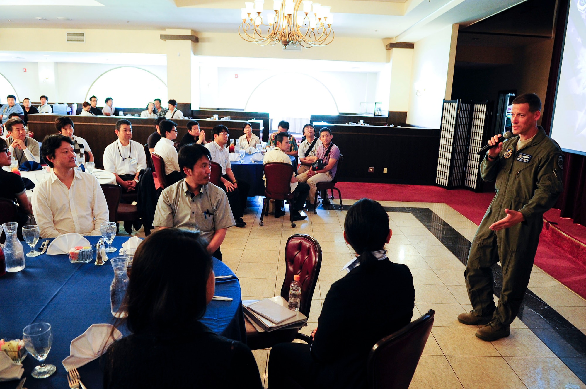 U.S. Air Force Col. Peter Milohnic, 18th Operations Group commander, welcomes and answers questions from Junior Chamber International Japan members during their study tour visit to Kadena Air Base, Japan, June 28, 2013. The Global Leader Development Committee is an educational program sponsored by Junior Chamber International Japan consisting of approximately 100 members. In this program, the members study key issues related to politics, economy, diplomacy, national defense, and U.S.-Japan relations to gain better understanding. (U.S. Air Force photo by Staff Sgt. Darnell T. Cannady/Released)