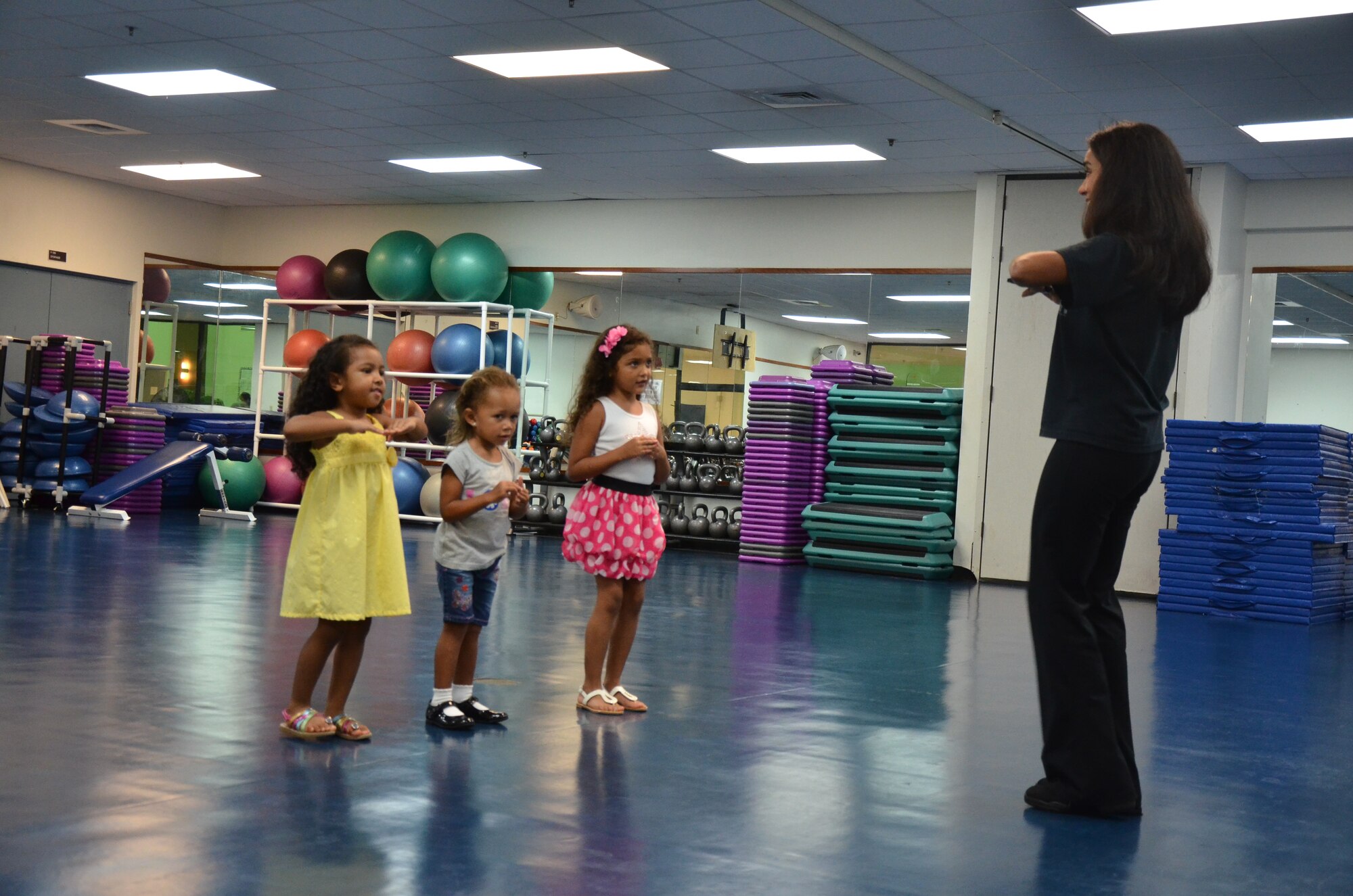 Adriana Bruton, a dance instructor on base, teaches students during a youth ballroom dance class on Andersen Air Force Base, Guam, June 26, 2013. Bruton instructs ages 3 and older and incorporates spelling and social skills into the curriculum. (U.S. Air Force photo by Staff Sgt. Veronica Montes/Released)
