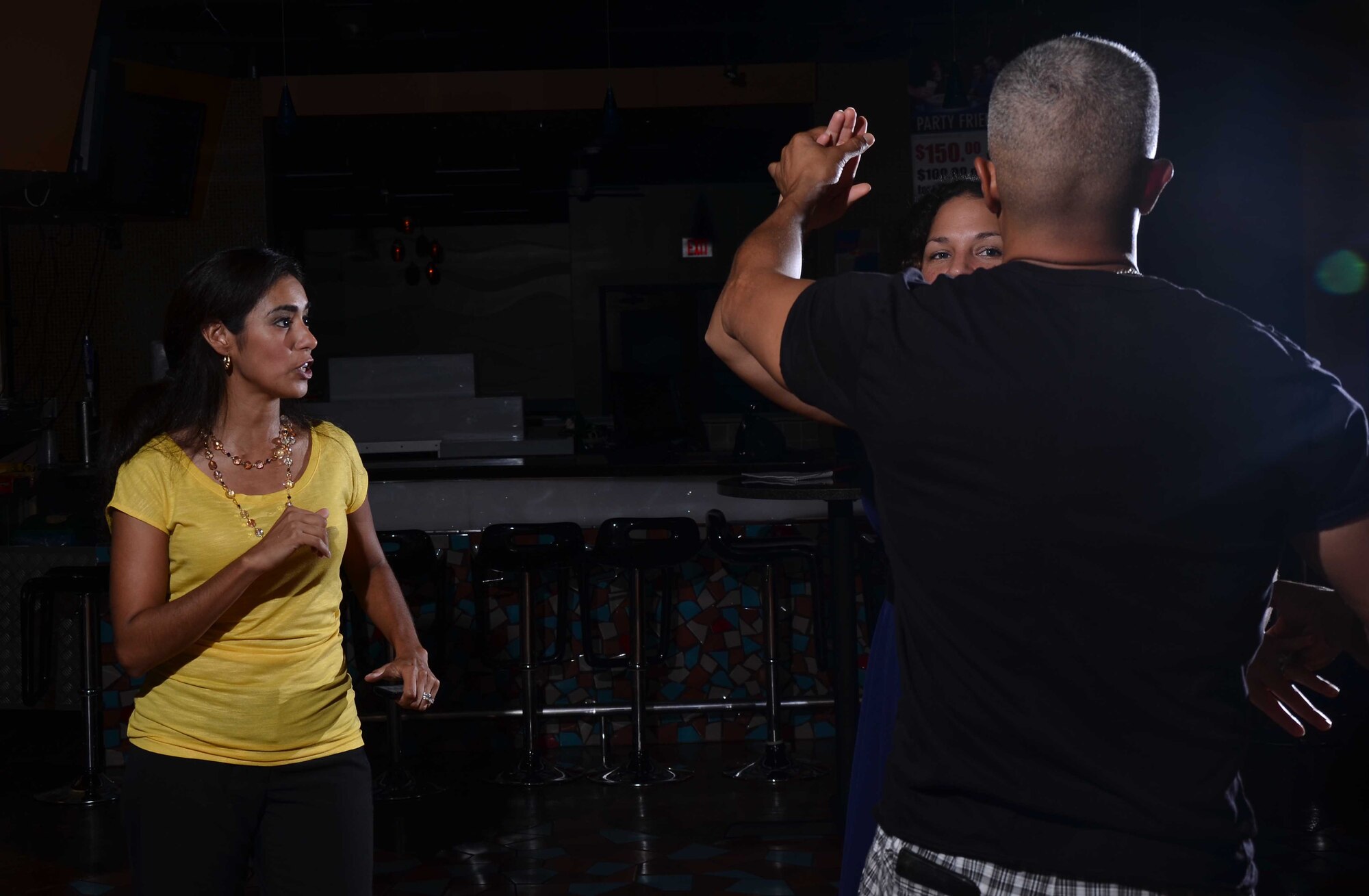Adriana Bruton, a dance instructor on base, teaches members of Team Andersen to dance the salsa during an adult ballroom dance class on Andersen Air Force Base, Guam, June 27, 2013. Adult classes are held Tuesday and Thursday nights at the Top of the Rock on base at 7 p.m. Each month she instructs different ballroom dances, including the fox-trot, waltz, tango, salsa, rumba, swing and merengue. (U.S. Air Force photo by Staff Sgt. Veronica Montes/Released)