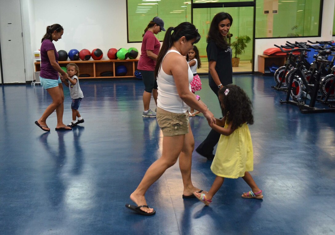 Adriana Bruton, a dance instructor on base, teaches students and their parents fox-trot during a youth ballroom dance class on Andersen Air Force Base, Guam, June 26, 2013. Bruton instructs ages 3 and older and allows parents to join in once a month to learn the steps with their children. (U.S. Air Force photo by Staff Sgt. Veronica Montes/Released)