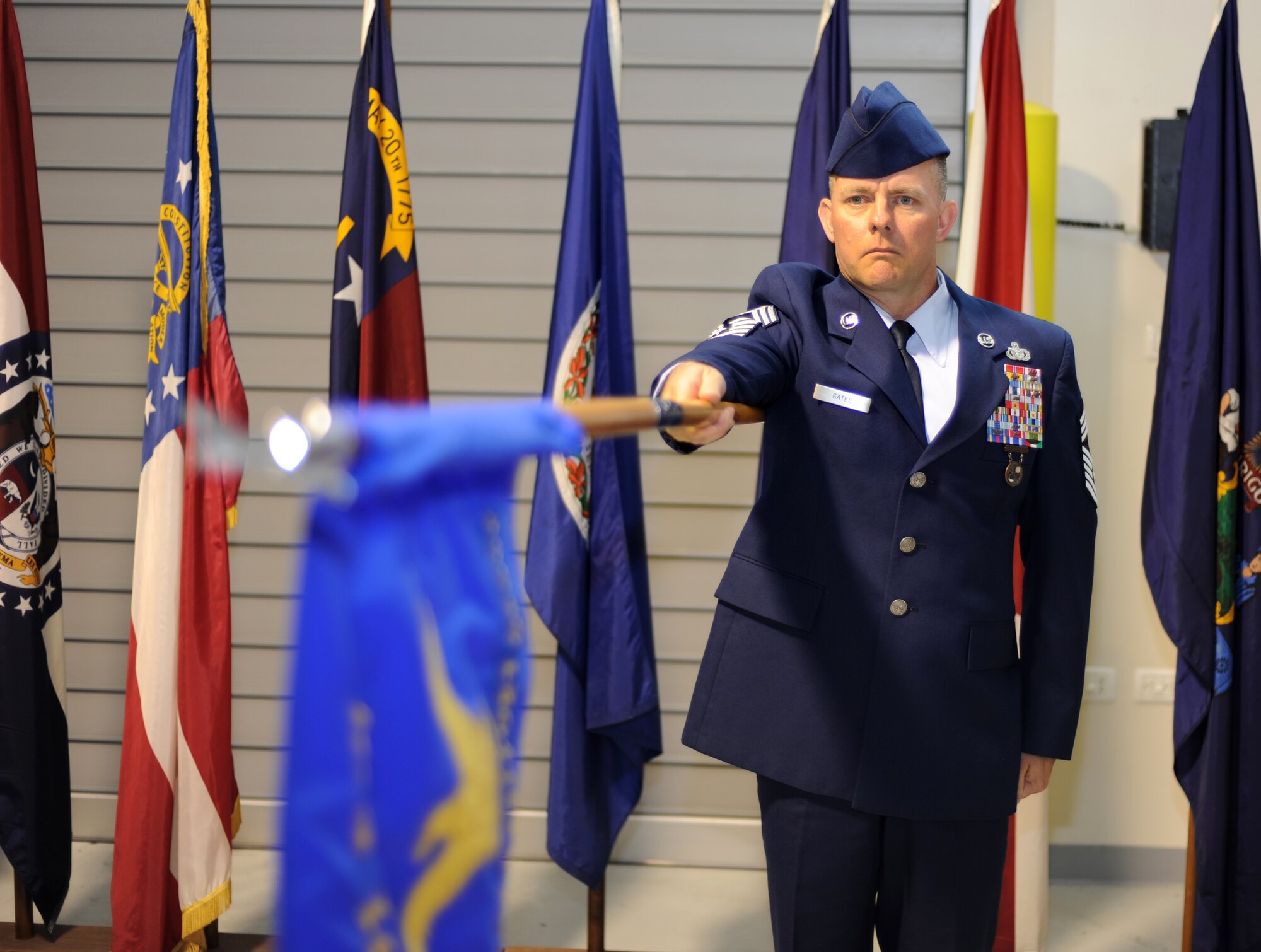 Chief Master Sgt. Brian Gates presents the guidon during the Italian and U.S. National Anthem at the 31st Mission Support Group change of command ceremony June 28, 2013, at Aviano Air Base, Italy. Nearly 500 people attended the ceremony and the audience included Airmen, Soldiers, Italian air force members and local community leaders. (U.S. Air Force photo/Staff Sgt. Justin Weaver)