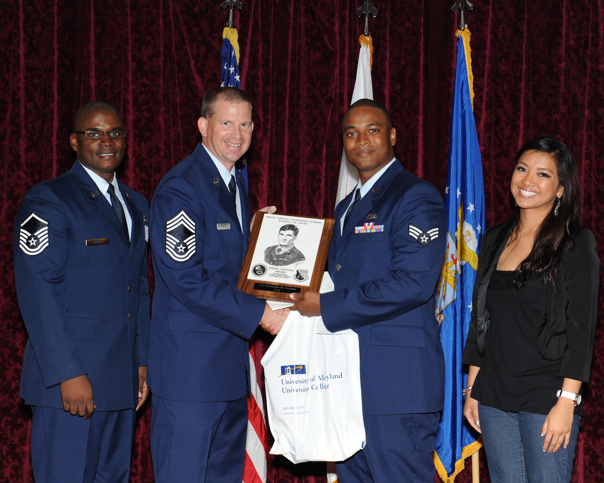 U.S. Air Force Senior Airman Alexander Graham, from the 353rd Special Operations Maintenance Squadron, receives the John L. Levitow Award during his Airman Leadership School graduation on Kadena Air Base, Japan, June 28, 2013. This award, which is named after the Medal of Honor recipient John L. Levitow, recognized Graham as the top of his class in a combined role as a leader and scholar. (U.S. Air Force photo by Airman 1st Class Keith James/Released)