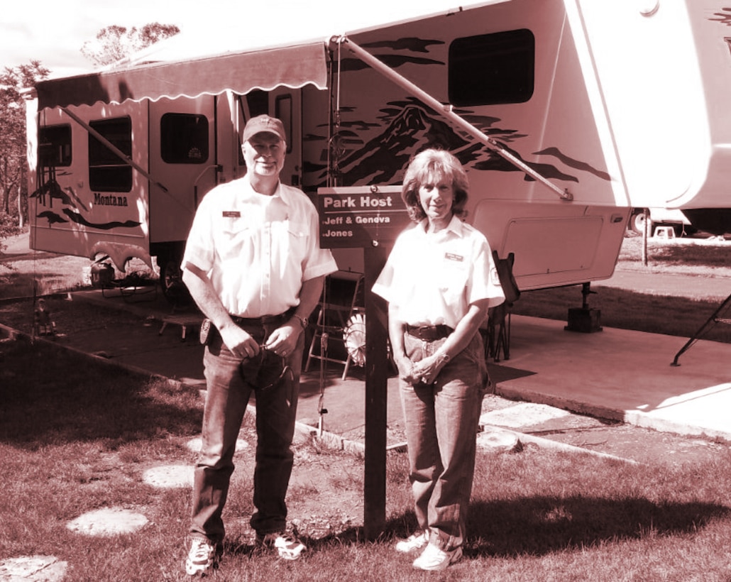 Jeff and Geneva Jones pose with their fifth wheel RV and big smiles at the camp host lot. 