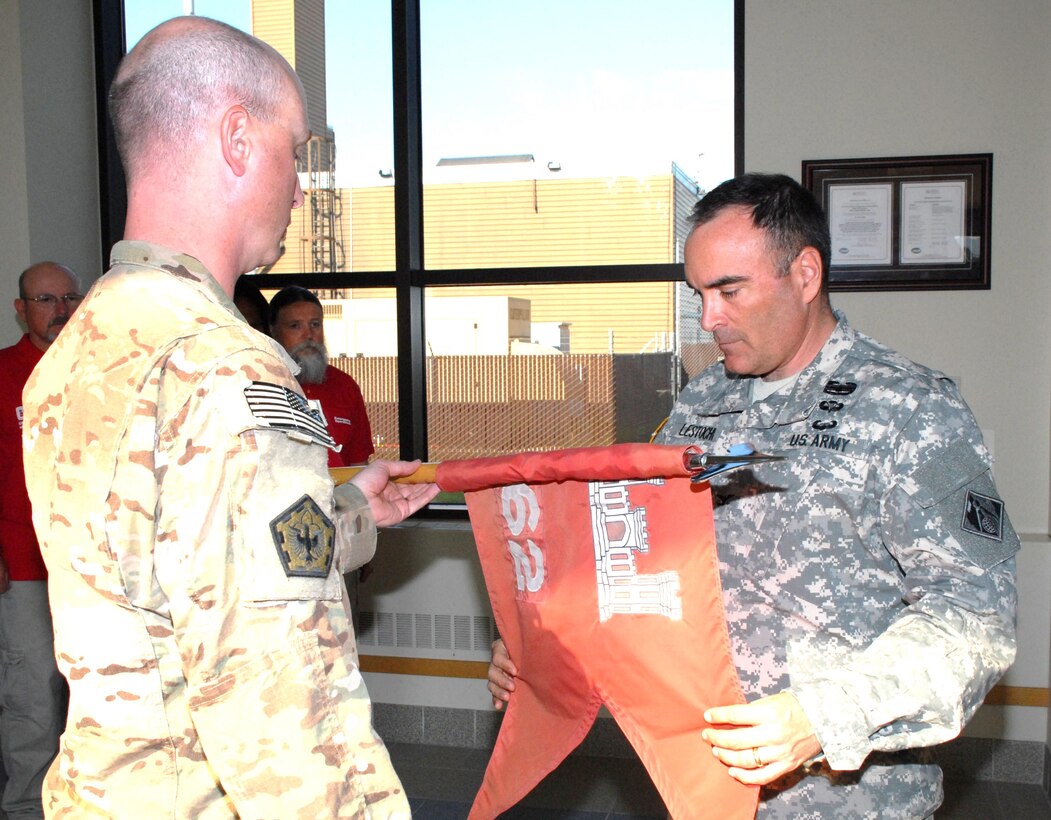 Col. Christopher Lestochi, district commander, uncases the colors of the 62nd Engineering Detachment with Capt. Corey Warren, detachment commander, during a ceremony June 26 at the district headquarters building. The team was deployed September 2012 through June 2013 in support of Operation Enduring Freedom at Shindand Air Base, Afghanistan.