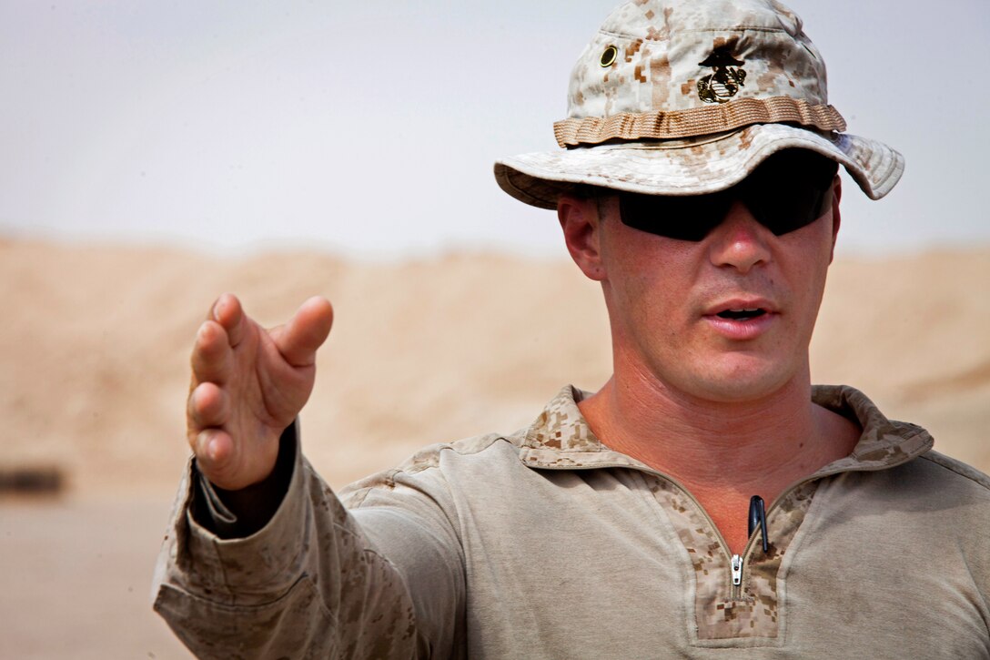 U.S. Marine Corps Staff Sgt. Caleb Hall delivers the safety brief before conducting small arms fire drills on Camp Leatherneck in Helmand province, Afghanistan, June 28, 2013. Hall is assigned to the 215th Afghan National Army Mobile Strike Force Security Force Assistance Advisor Team.