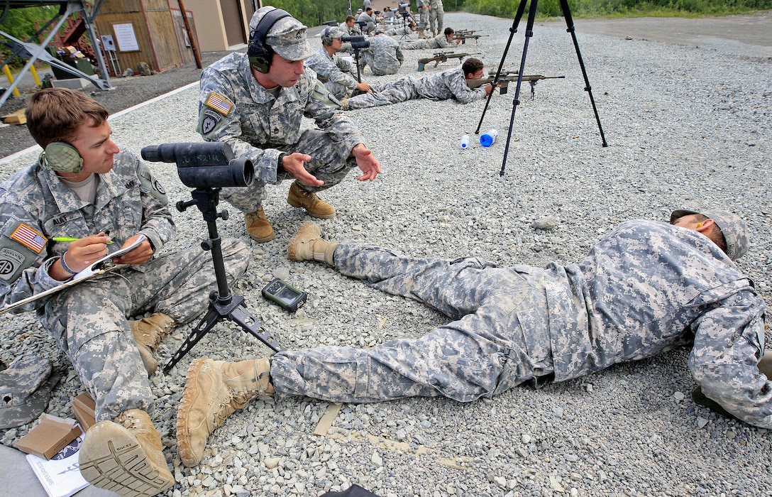 Army Sgt. 1st Class Adam James, center, gives aiming instructions to Army Spc. Scott Ault, left, and Army Pfc. Kyle Russell, right, during the M110 semi-automatic sniper system qualifications at Grezelka Range on Joint Base Elmendorf-Richardson, Alaska, June 25, 2013. James is assigned to Company C, 2nd Battalion, 29th Infantry Regiment, U.S. Army Sniper School, Fort Benning, Ga.; and Ault and Russell are assigned to C Troop, 1st Squadron, Airborne, 40th Cavalry Regiment.