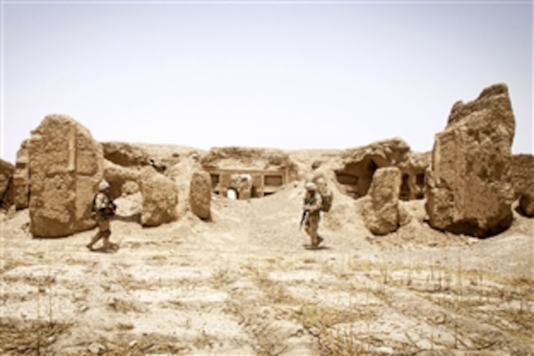 U.S. Navy Petty Officer 1st Class William Neason, left, and U.S. Marine Corps 1st Lt. Stephen T. Desmond, right, patrol through the ruins of a 200-year-old castle during Operation Northern Lion in Mohammad Abad village in Helmand province, Afghanistan, June 24, 2013. Neason, a hospital corpsman, and Desmond are assigned to Georgian Liaison Team-9.