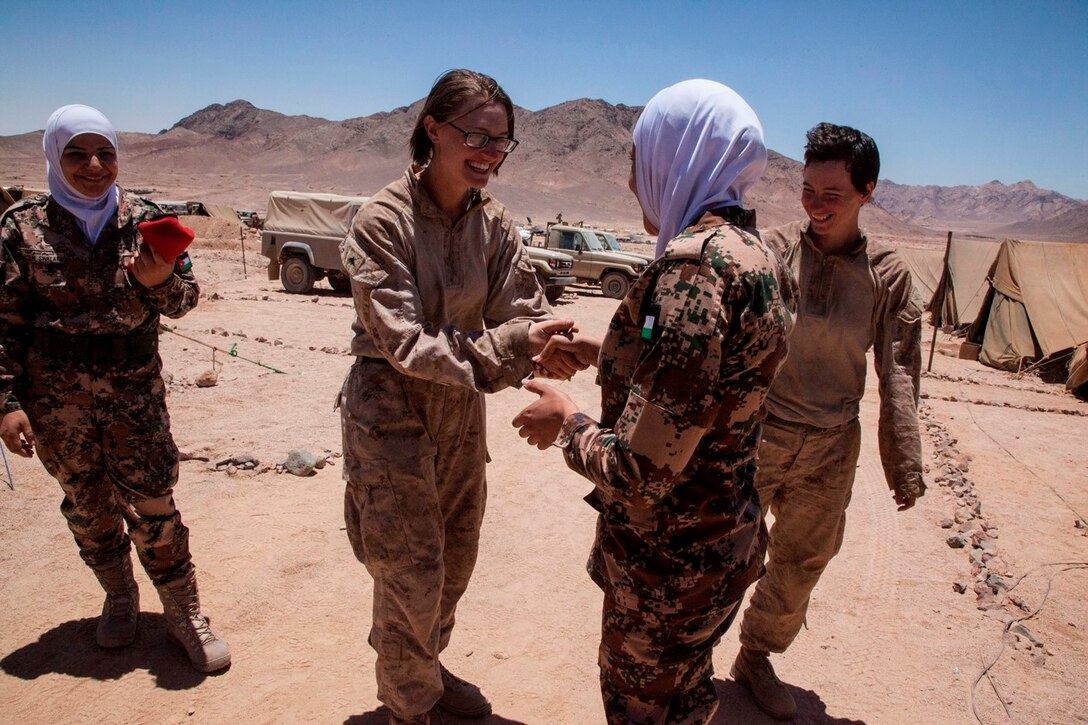 U.S. Marine Corps Lance Cpl. Amber Borysewicz, 26th Marine Expeditionary Unit (MEU), shakes hands with a Jordanian Armed Forces soldier as part of female engagement team training during Exercise Eager Lion 2013 in Al Quweira, Jordan, June 14, 2013. Exercise Eager Lion 2013 is an annual multinational exercise designed to strengthen military-to-military relationships and enhance security and stability in the region by responding to modern-day security scenarios. The 26th MEU is a Marine Air-Ground Task Force forward-deployed to the U.S. 5th Fleet area of responsibility aboard the Kearsarge Amphibious Ready Group serving as a sea-based, expeditionary crisis response force capable of conducting amphibious operations across the full range of military operations. (U.S. Marine Corps photo by Staff Sgt. Edward Guevara/Released)
