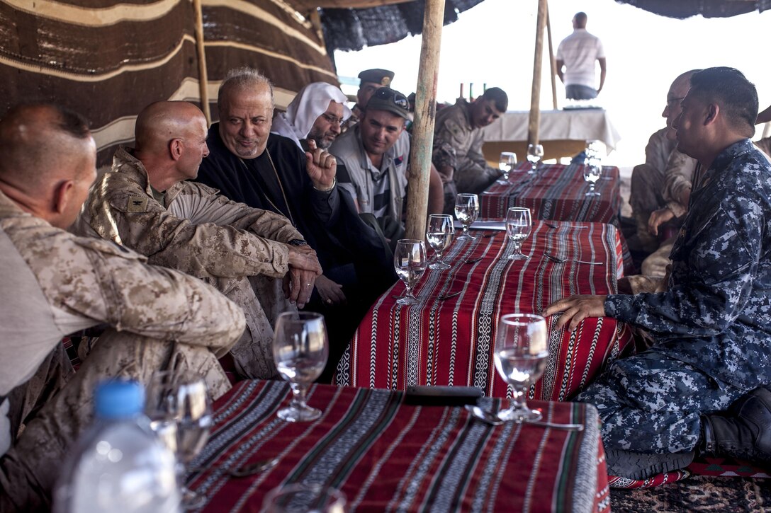 U.S. Marines and Sailors shared a spiritual exchange hosted by the 26th Marine Expeditionary Unit (MEU) with Jordanian Armed Forces Col. Jamel Al Sbool, imam for the Jordanian Armed Forces in the southern region and the Very Reverend Nabil Haddad, founder of an interfaith tolerance organization in Jordan, during Exercise Eager Lion 2013 in Al Quweira, Jordan, June 14, 2013. Exercise Eager Lion 2013 is an annual multinational exercise designed to strengthen military-to-military relationships and enhance security and stability in the region by responding to modern-day security scenarios. The 26th MEU is a Marine Air-Ground Task Force forward-deployed to the U.S. 5th Fleet area of responsibility aboard the Kearsarge Amphibious Ready Group serving as a sea-based, expeditionary crisis response force capable of conducting amphibious operations across the full range of military operations. (U.S. Marine Corps photo by Staff Sgt. Edward Guevara/Released)