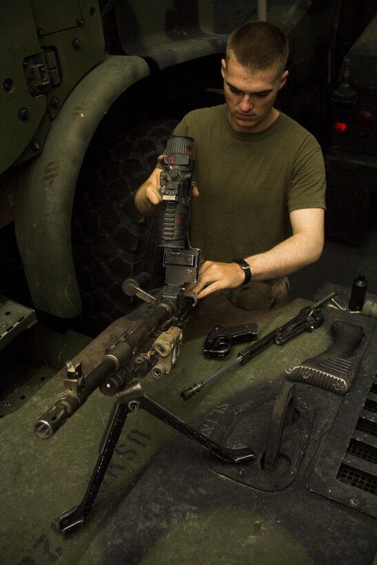 U.S. Marine Corps Lance Cpl. Robert F. Thornton III, a machine gunner assigned to Company L, Battalion Landing Team 3/2, 26th Marine Expeditionary Unit (MEU), from Poca, W. Va., cleans his M240B machine gun aboard the USS San Antonio (LPD 17), June 24, 2013. The 26th MEU is a Marine Air-Ground Task Force forward deployed to the U.S. 5th Fleet area of responsibility aboard the Kearsarge Amphibious Ready Group serving as a sea-based, expeditionary crisis response force capable of conducting amphibious operations across the full range of military operations. (U.S. Marine Corps photo by Lance Cpl. Juanenrique Owings, 26th MEU Combat Camera/Released)