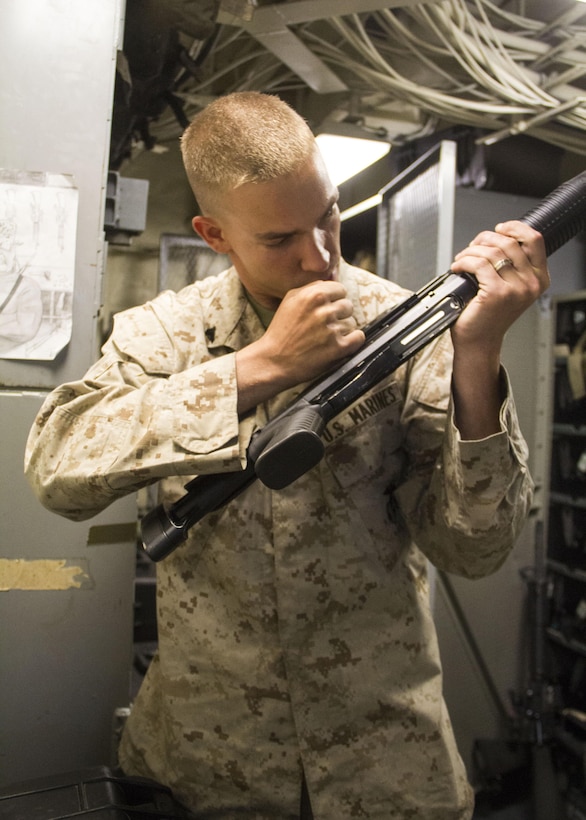 U.S. Marine Corps Cpl. Jonathan H. Carlson, 3rd Echelon Armorer assigned to Combat Logistics Battalion 26, from Chicago, Ill., conducts a pre fire inspection on an M1014 shotgun aboard the USS San Antonio (LPD 17), June 29, 2013. The 26th MEU is a Marine Air-Ground Task Force forward deployed to the U.S. 5th Fleet area of responsibility aboard the Kearsarge Amphibious Ready Group serving as a sea-based, expeditionary crisis response force capable of conducting amphibious operations across the full range of military operations. (U.S. Marine Corps photo by Lance Cpl. Juanenrique Owings, 26th MEU Combat Camera/Released)